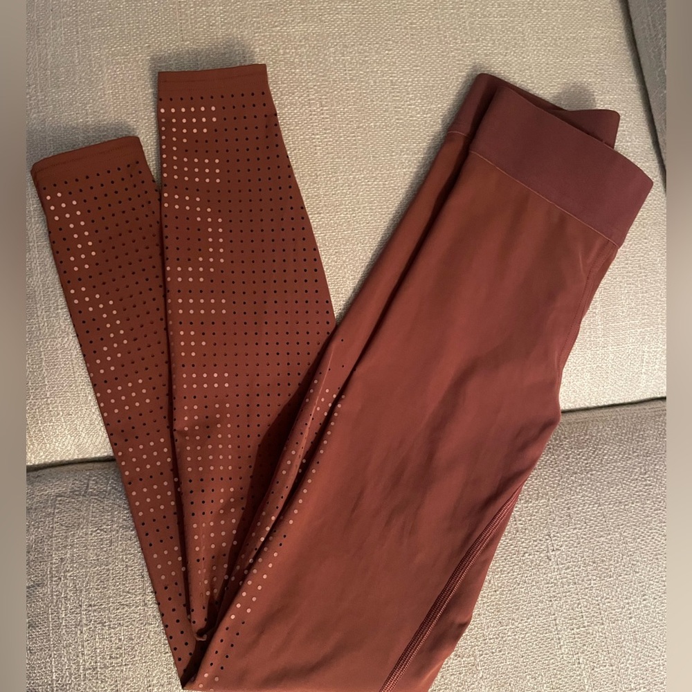 Lululemon  X SoulCycle brown leggings with writing in tiny holes style!